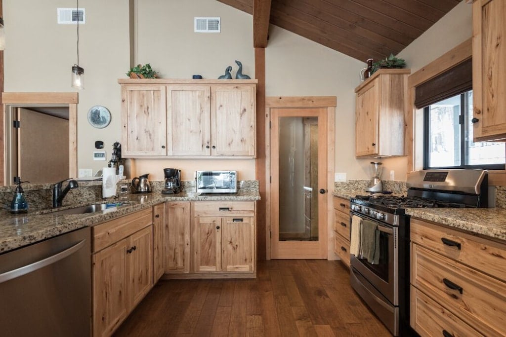 Remodeled kitchen with stainless appliances and warm wood finishes.