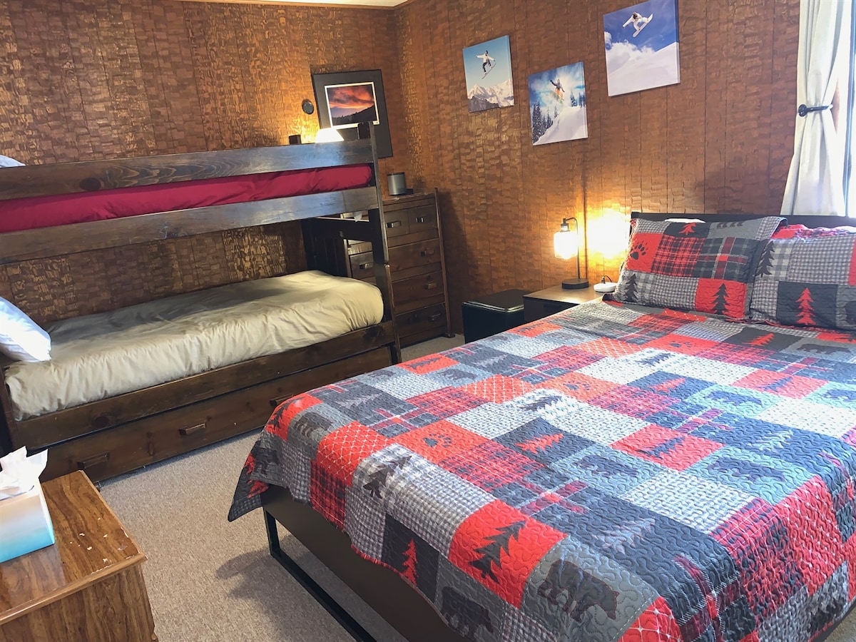Bunk room with queen bed plus twin bunk beds.