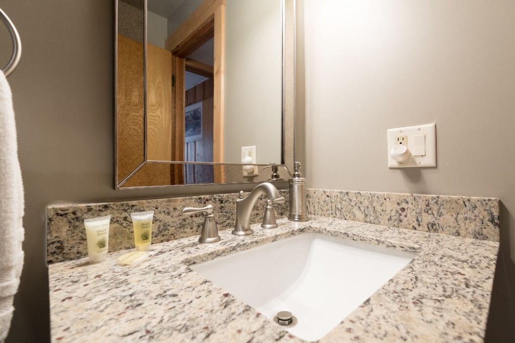 Back bathroom vanity with granite counter.