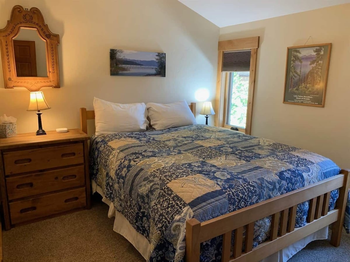 Middle bedroom with queen bed and natural light.