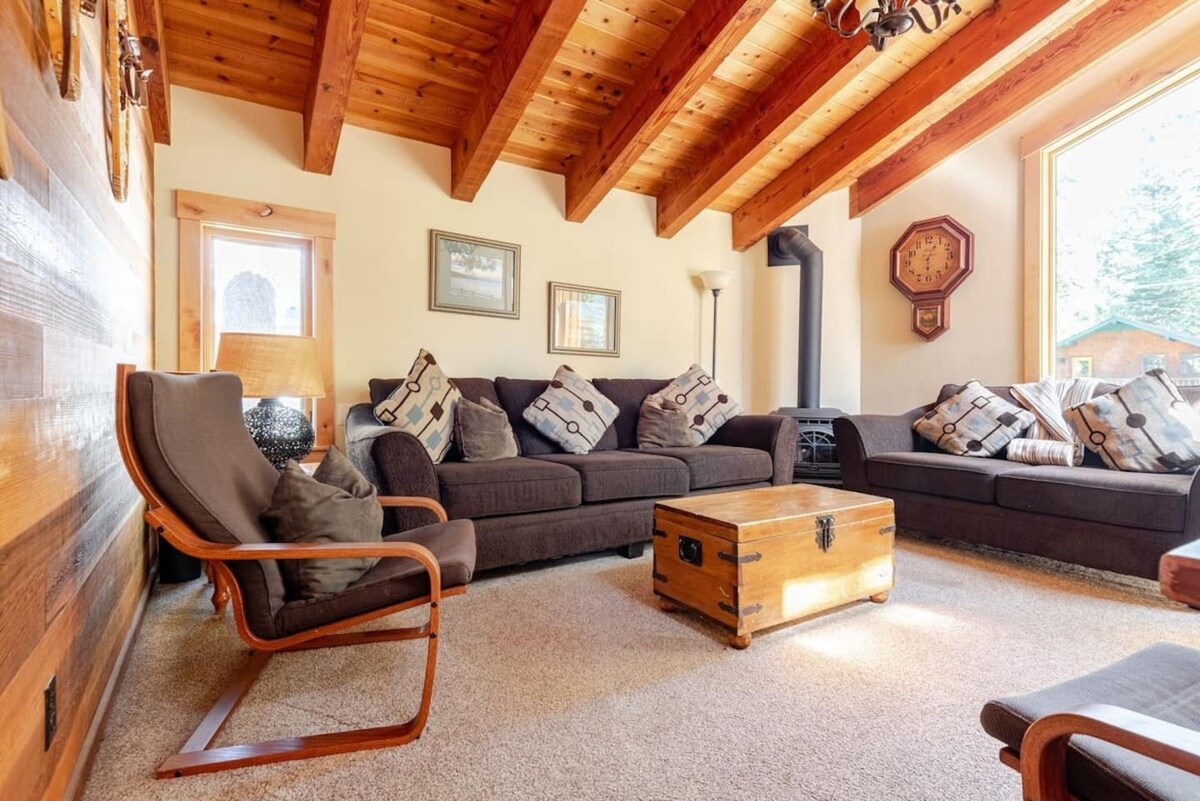 Spacious living room with sofas, armchair, and coffee chest.